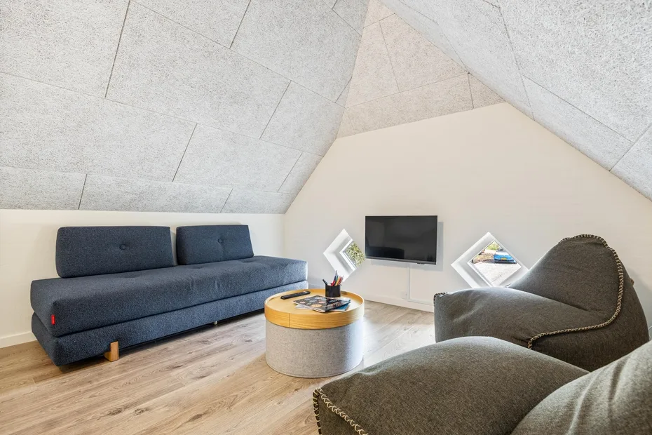 A living room with seating, a television, and a round coffee table.