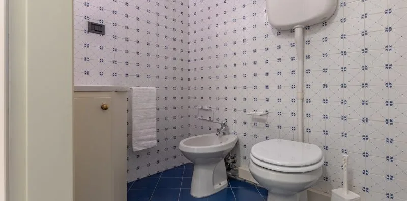 A tiled bathroom with a sink and toilet.