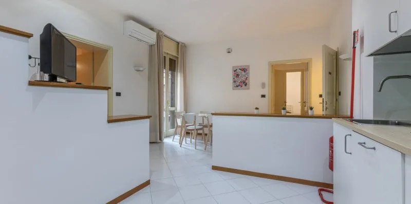 A bright kitchen and dining area with a counter and table.