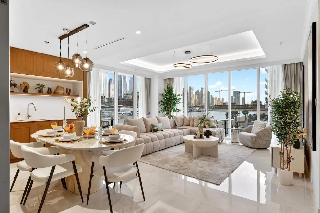 A bright open-plan living and dining area with large windows overlooking the city.