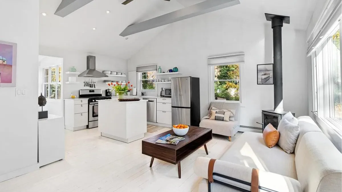 An open-plan kitchen and living area with a central island and seating.