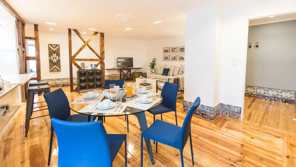 Un comedor con asientos azules y una mesa puesta.