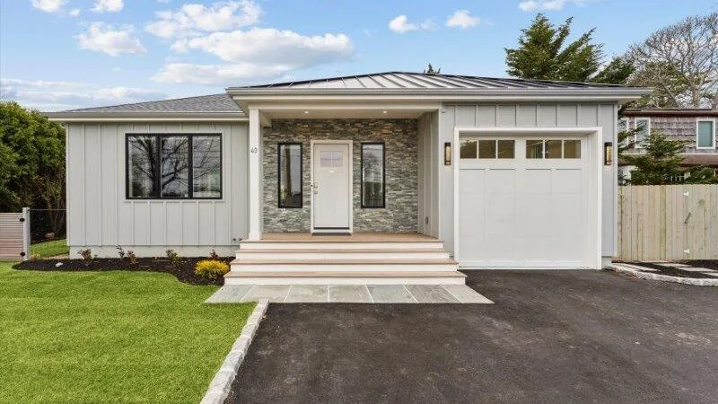 A single-story house with a covered front entry, garage, and driveway.