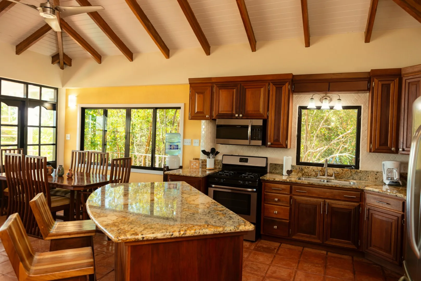 A kitchen with dark wood cabinets and a large central island.