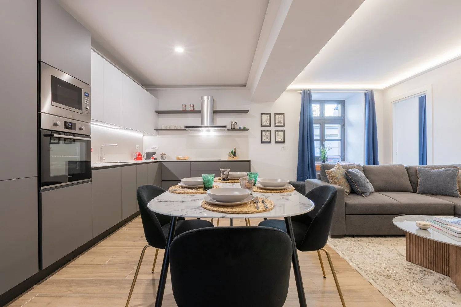 An open-plan kitchen and dining area with a table beside the living room.