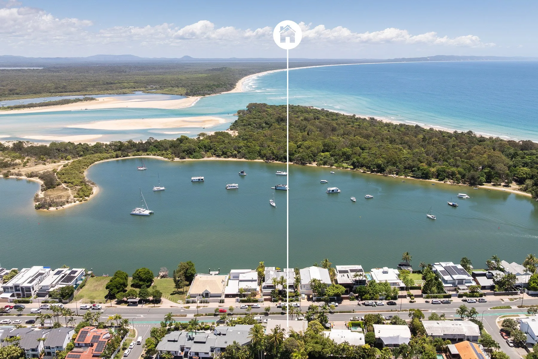 An aerial view shows a coastal town beside a lagoon and ocean.