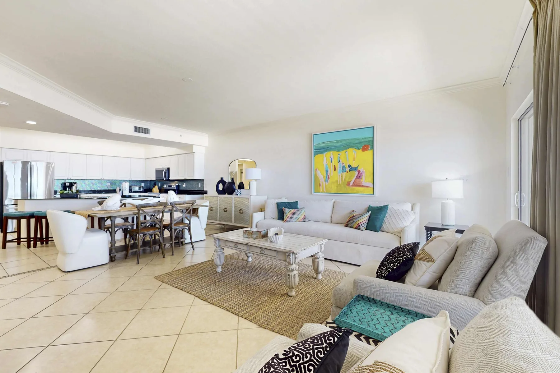 An open-plan living room and kitchen with a sofa, dining table, and coffee table.