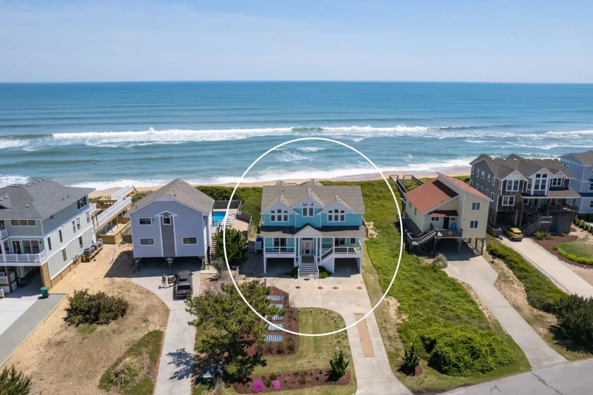 Beachfront homes face the ocean, with a circled house among the coastal residences.
