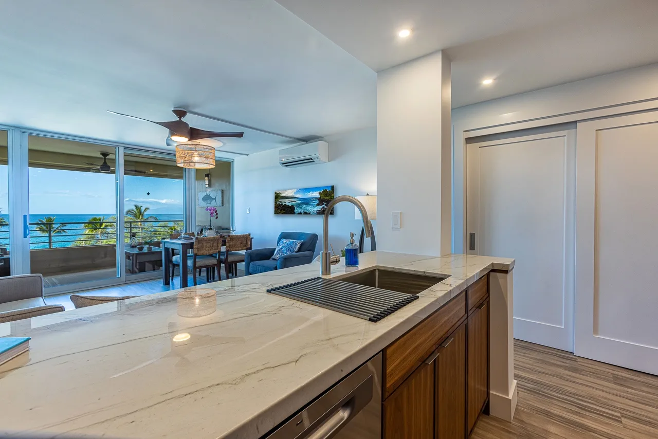 Cocina y sala de estar de concepto abierto, con una encimera frente a la zona de asientos.
