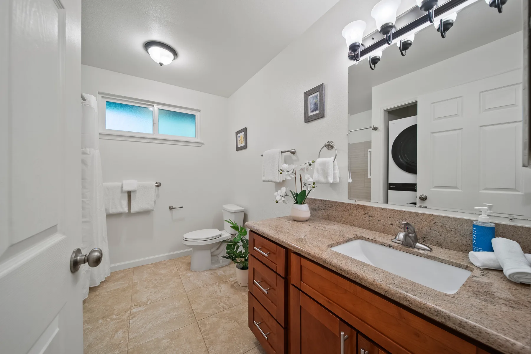 A bathroom with a long vanity and a bathtub.