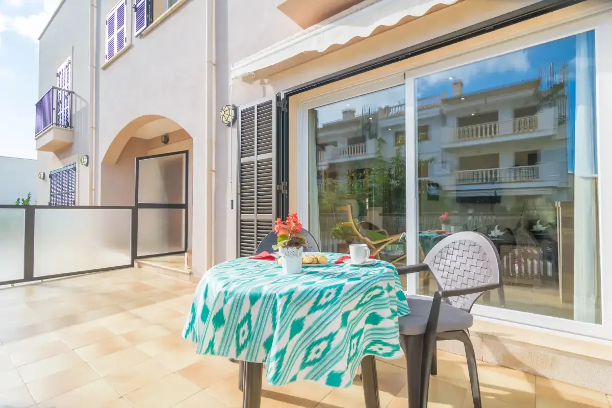 A patio dining area sits beside large sliding glass doors.