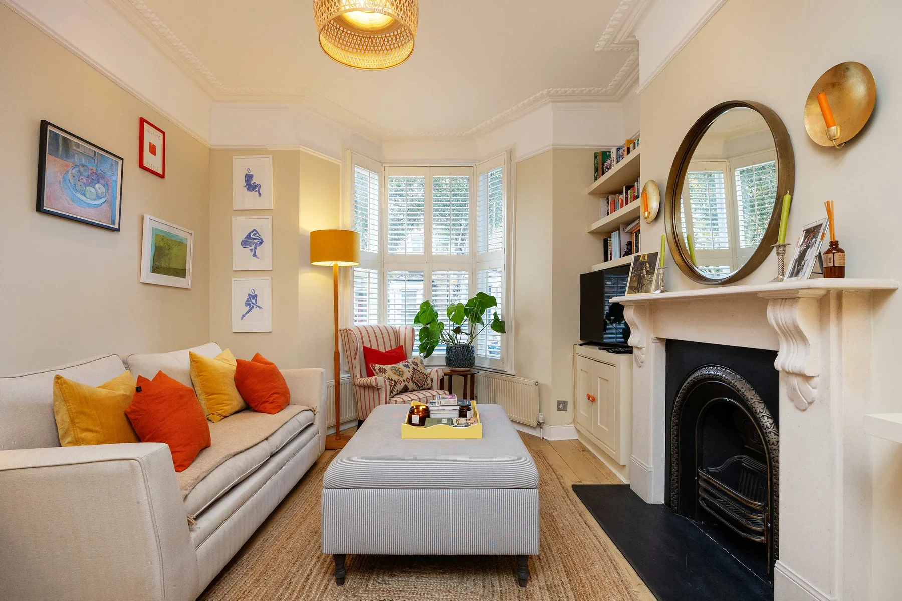 A bright living room with seating, a coffee table, and a fireplace.
