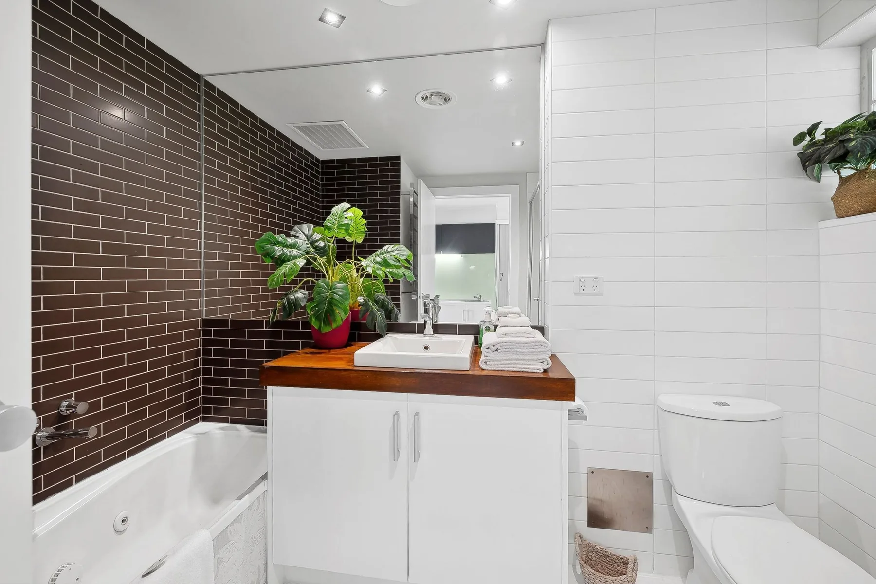 A bathroom with a bathtub, sink, and toilet.