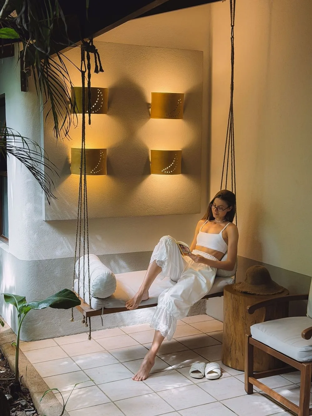 Guest relaxing on a hanging swing chair