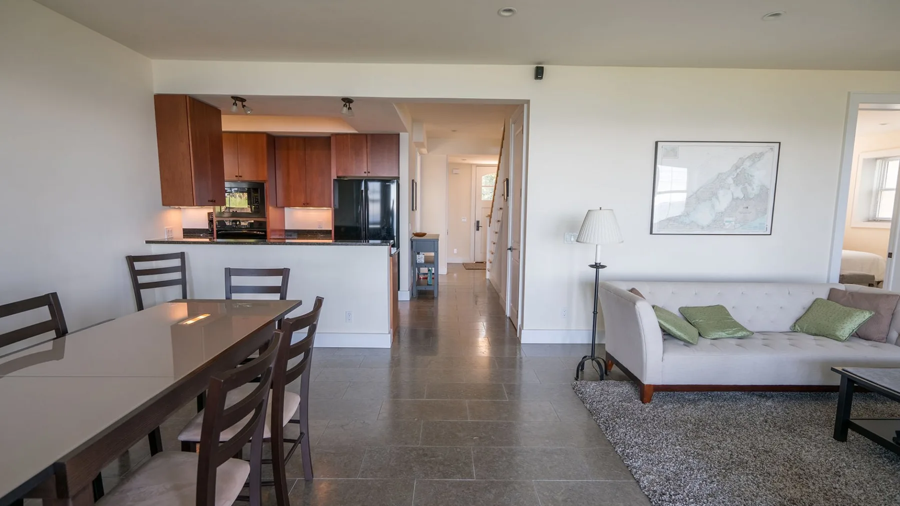 An open-plan living and dining area with a kitchen and dining table.