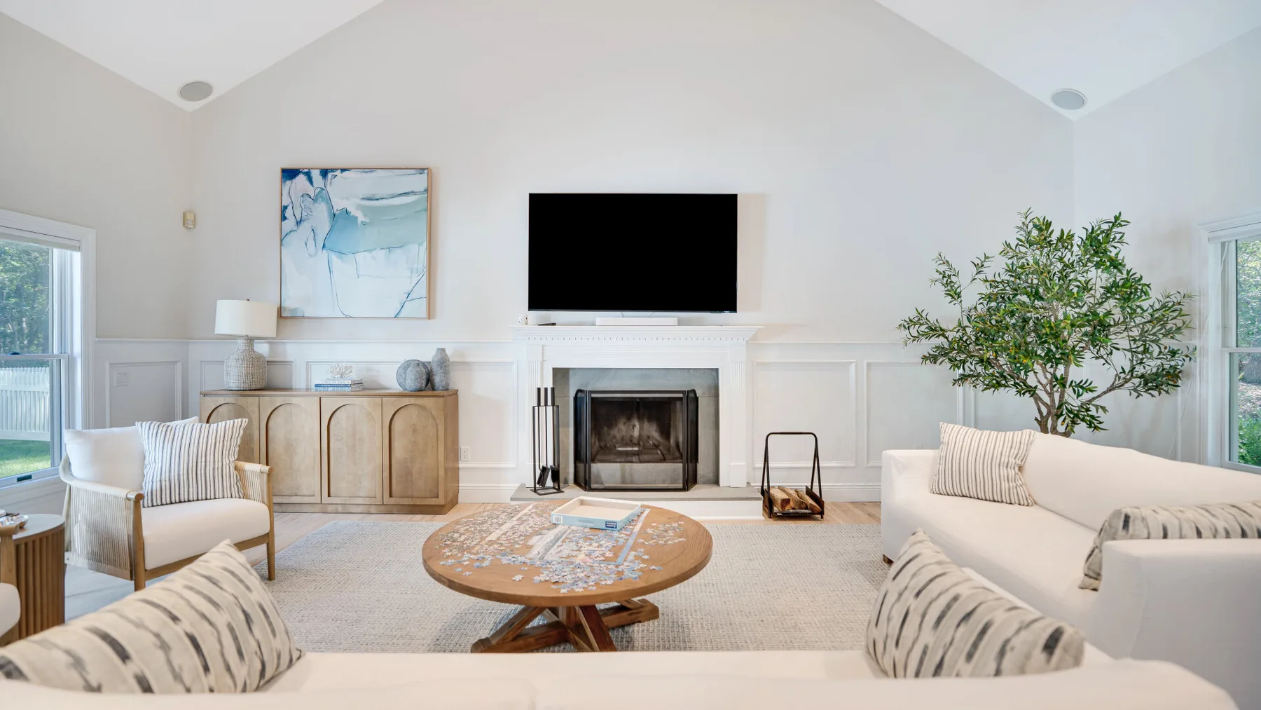 Una sala luminosa con asientos, una chimenea y un televisor.