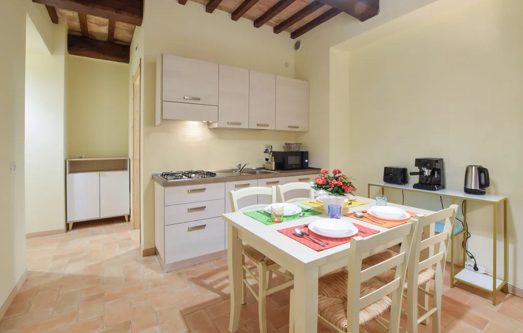A kitchen and dining area with a table set for a meal.
