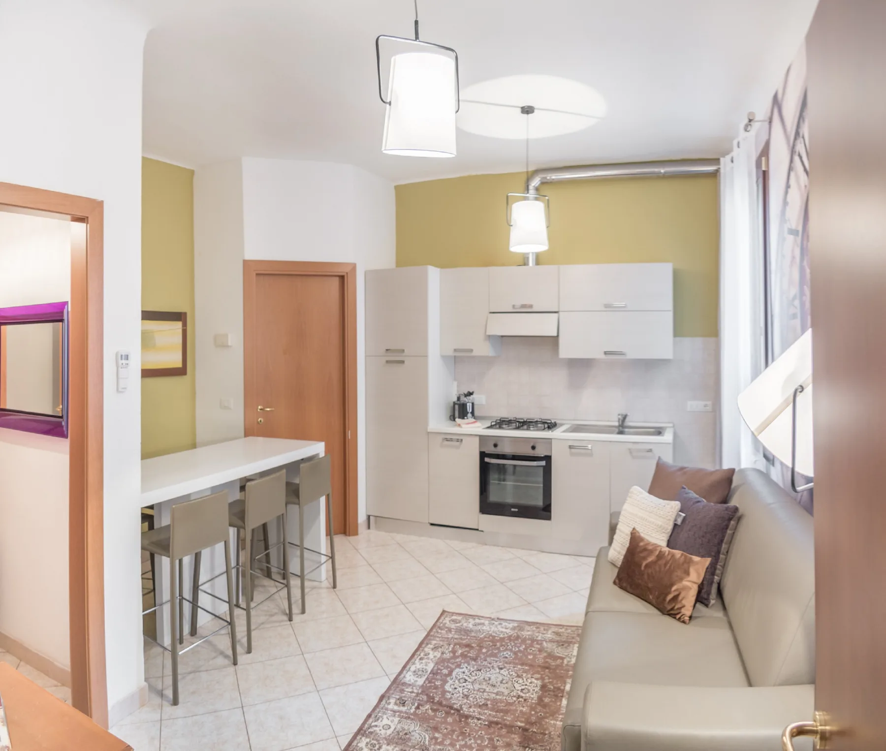 An open-plan kitchen and living area with a counter and seating.