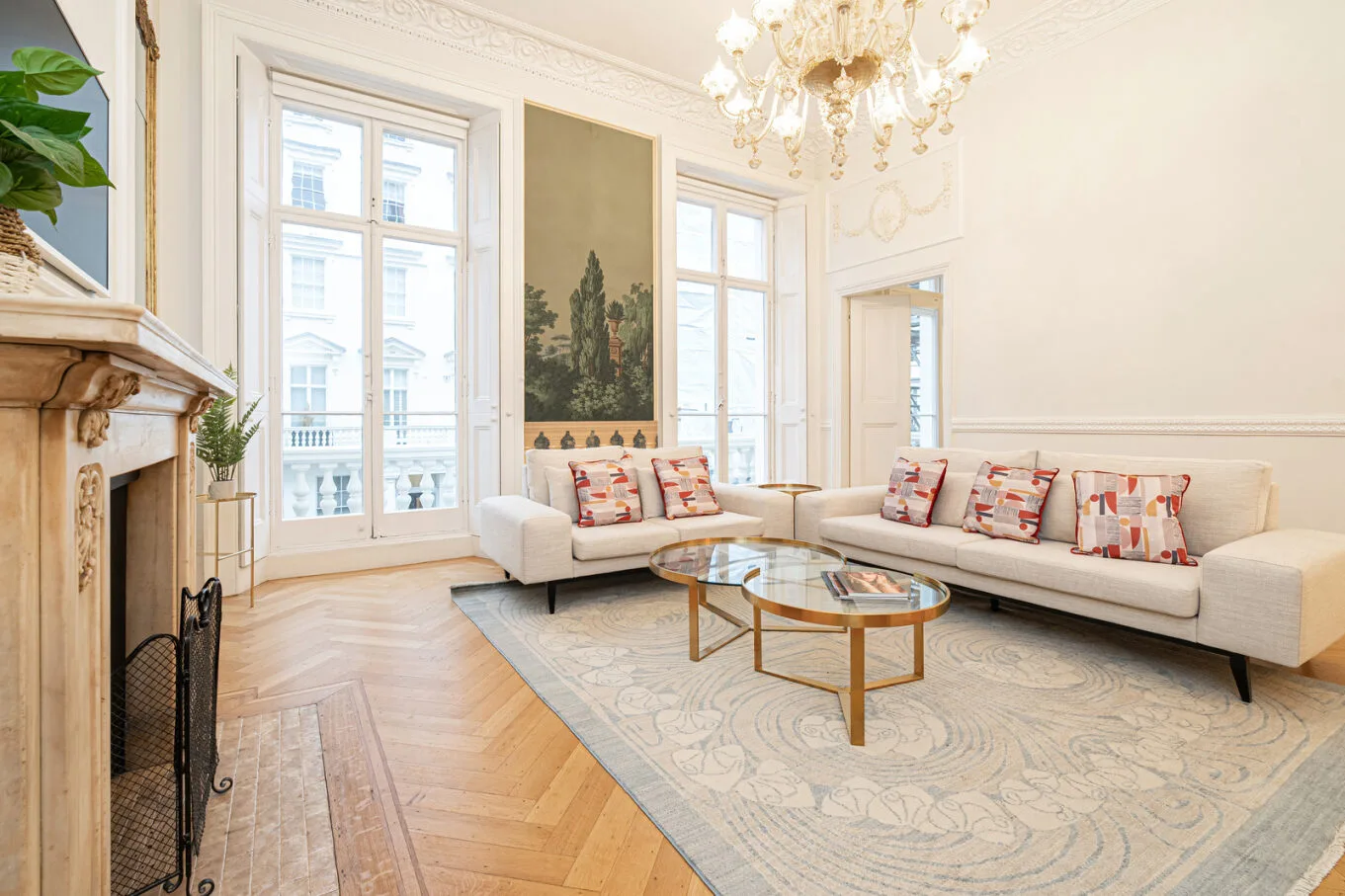 A bright living room with seating arranged around a glass coffee table.