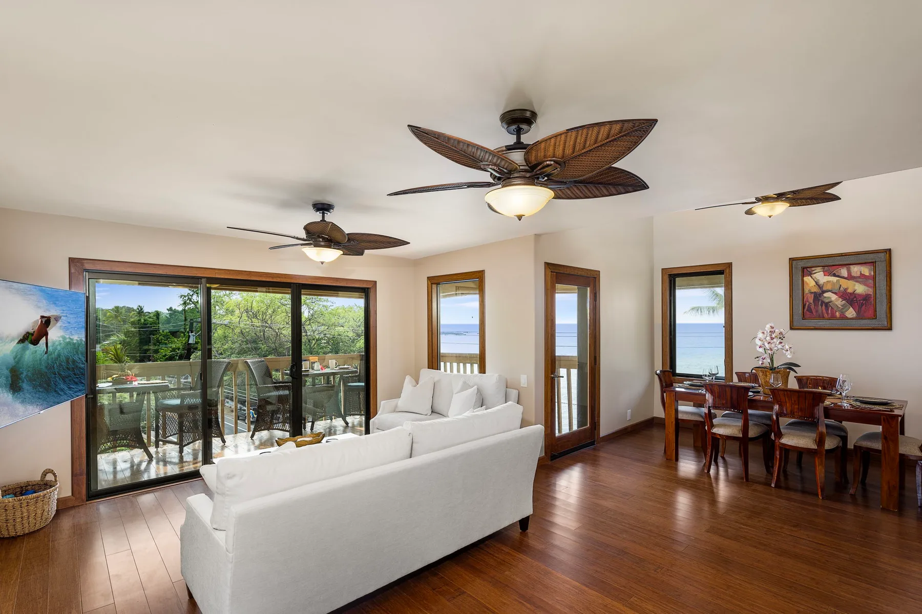 A bright living and dining area opens onto a patio through large sliding glass doors.