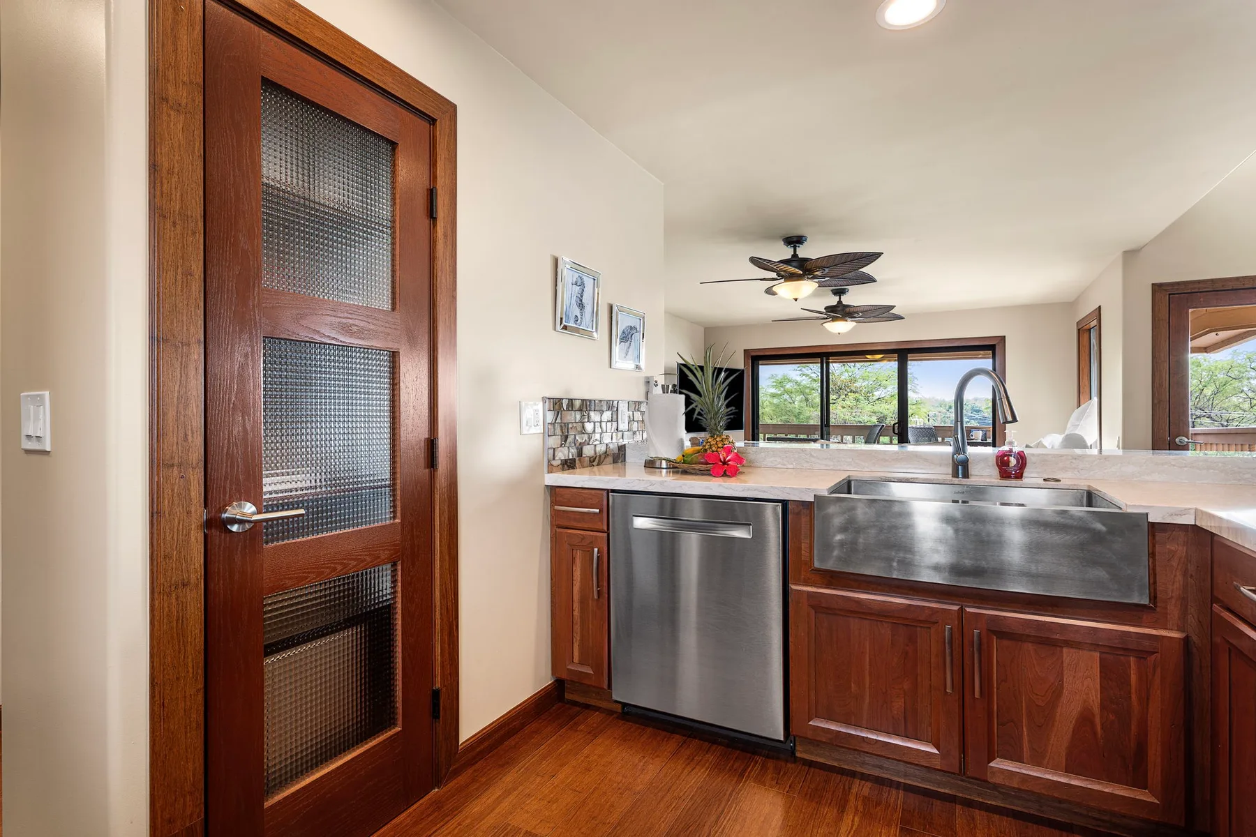 A kitchen with wooden cabinets, stainless steel appliances, and a large sink.