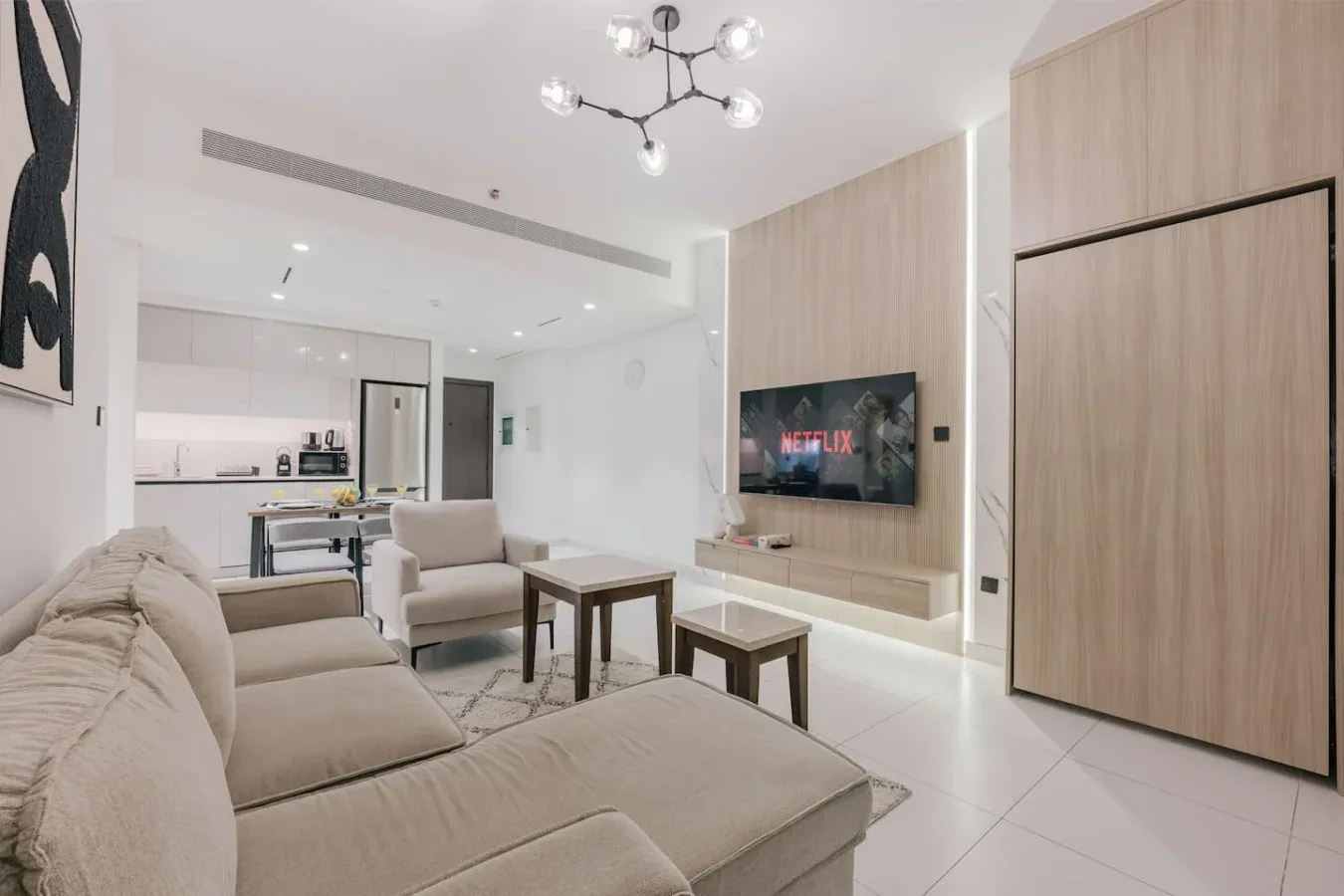 Una sala luminosa con asientos, una mesa de centro y un televisor.