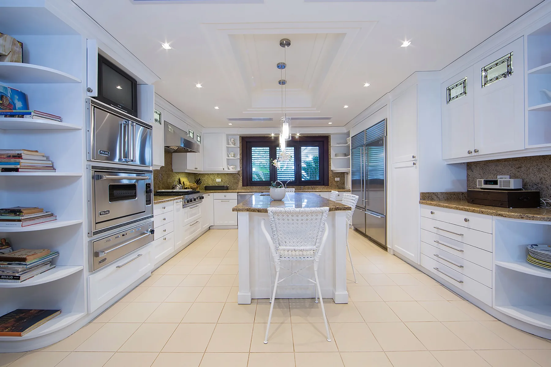 A bright kitchen with a central island and white cabinetry.