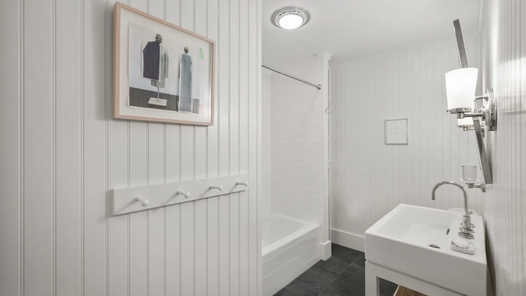 A bright bathroom with a bathtub and a sink.