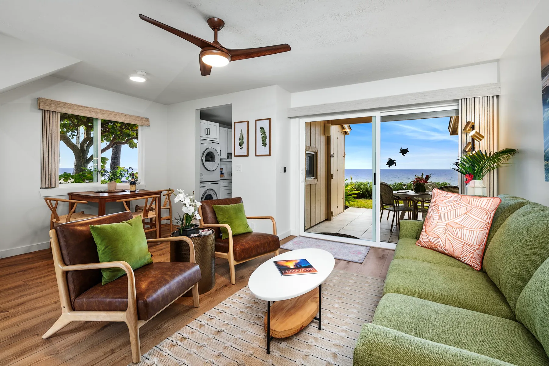 A bright living room with seating, a coffee table, and sliding doors opening to a patio.