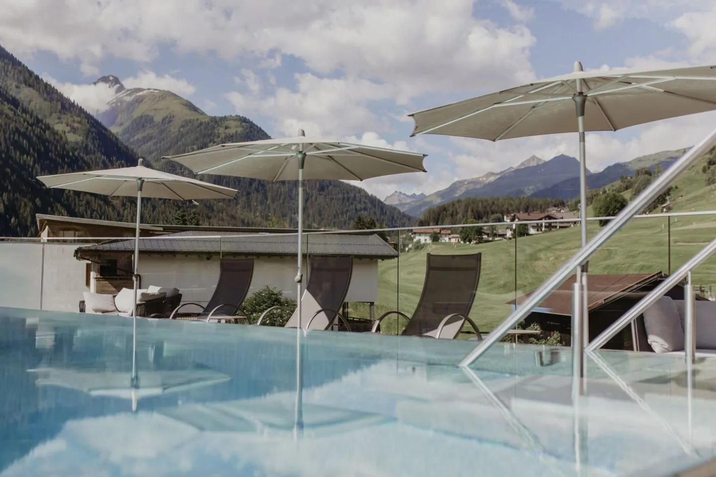 Rooftop pool with loungers and mountain views