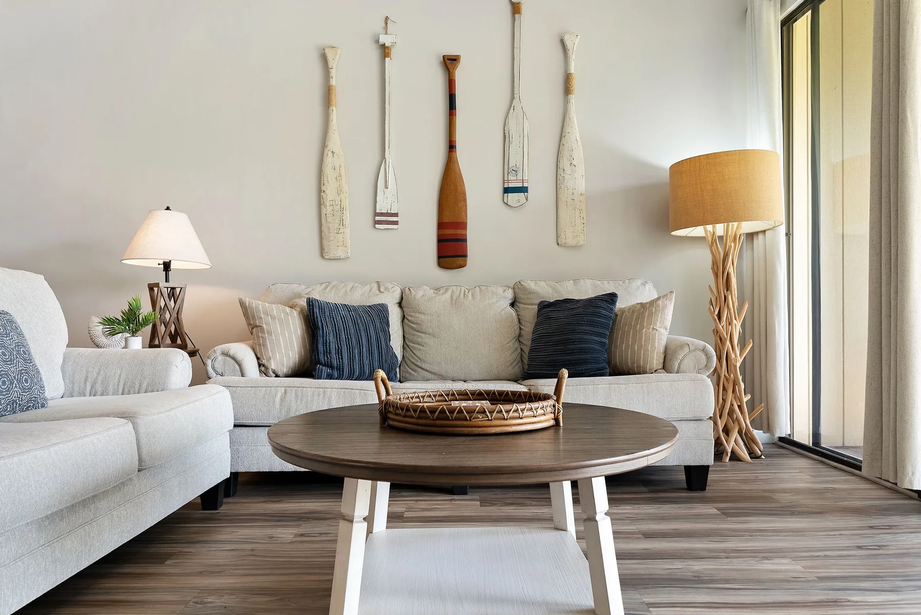 A bright living room with a sofa and a round coffee table.