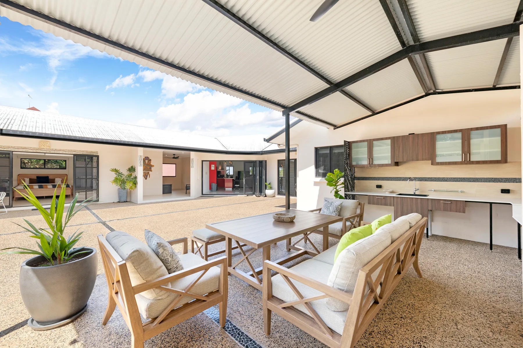 Enjoy alfresco living beneath the covered patio, where a cushioned lounge, large table and outdoor kitchenette set the scene for leisurely lunches beside the courtyard.