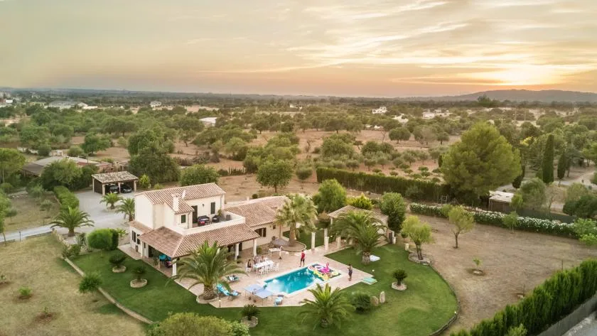 Vista aérea de una propiedad rural con casa, jardín y piscina.
