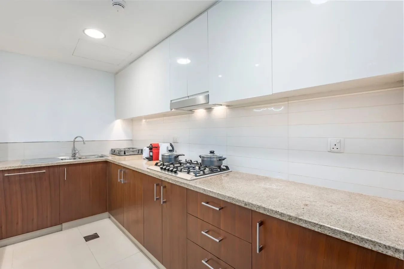 Una cocina moderna con gabinetes color madera y una estufa sobre la encimera.
