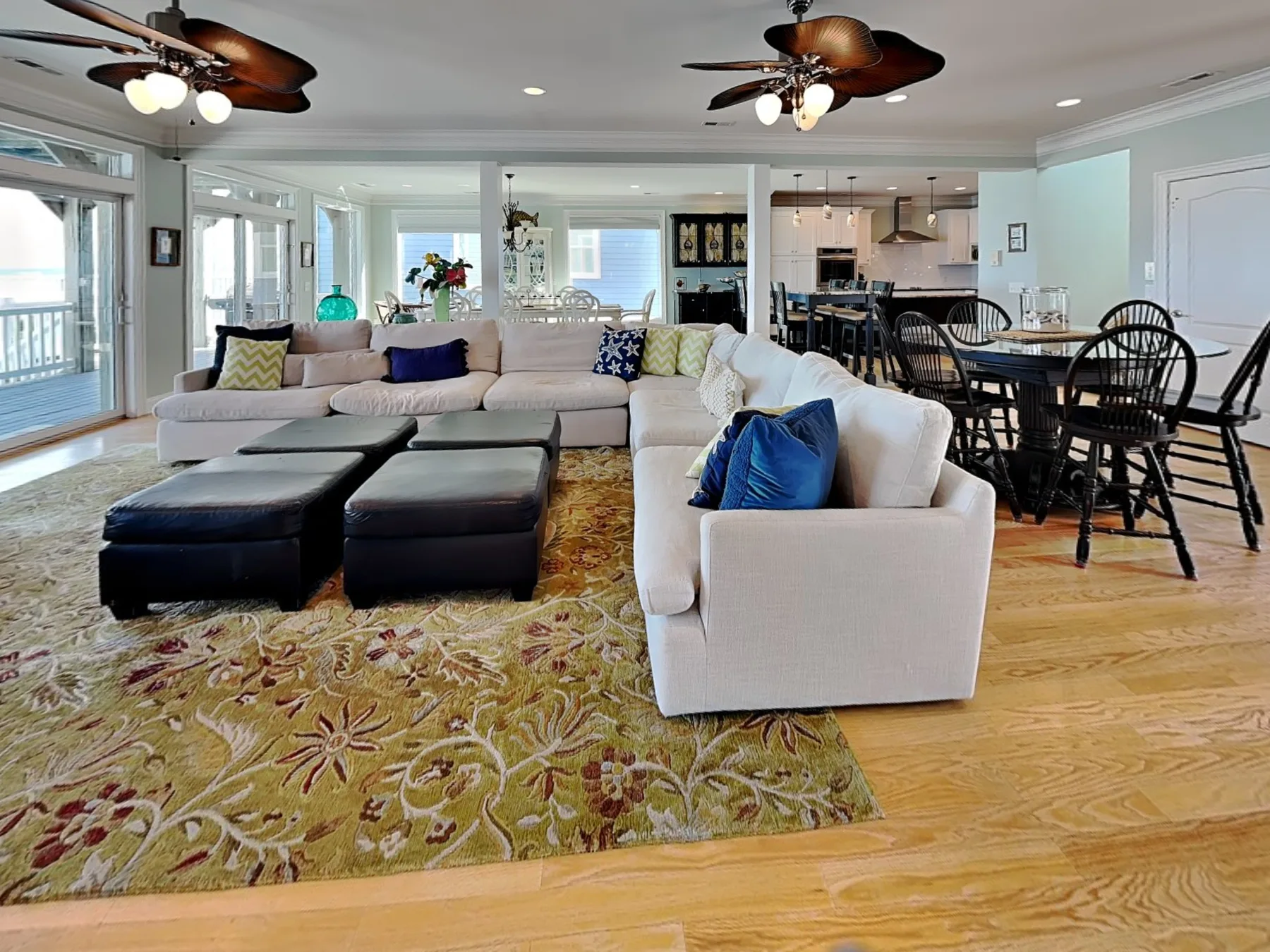 An open-plan living and dining area with light-colored seating and a dining table.