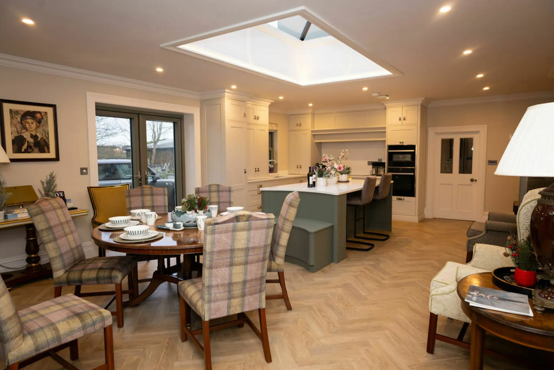 An open-plan dining and kitchen area with a table and central island.