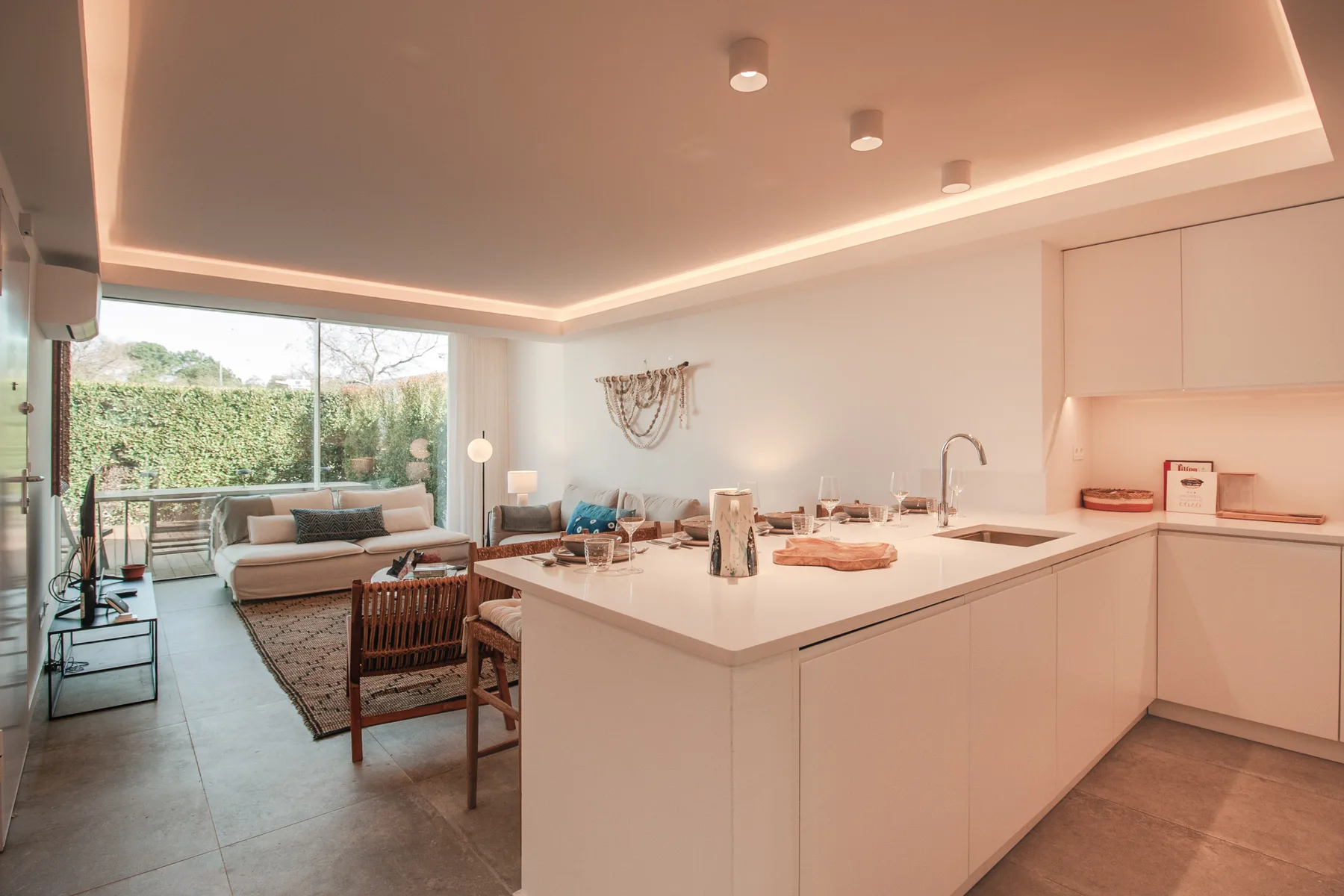 An open-plan living area and kitchen, with a dining table beside the seating area.