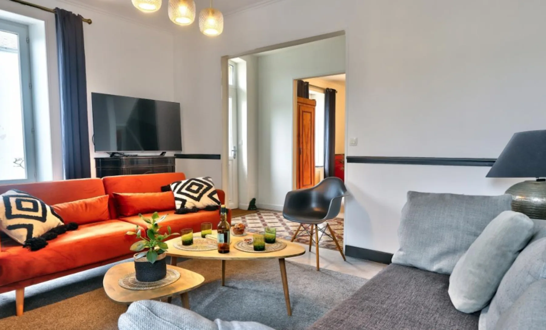 Living room with colorful seating and a coffee table.