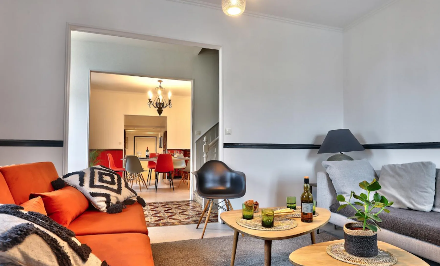 A living room with seating around a coffee table and an adjoining dining area.