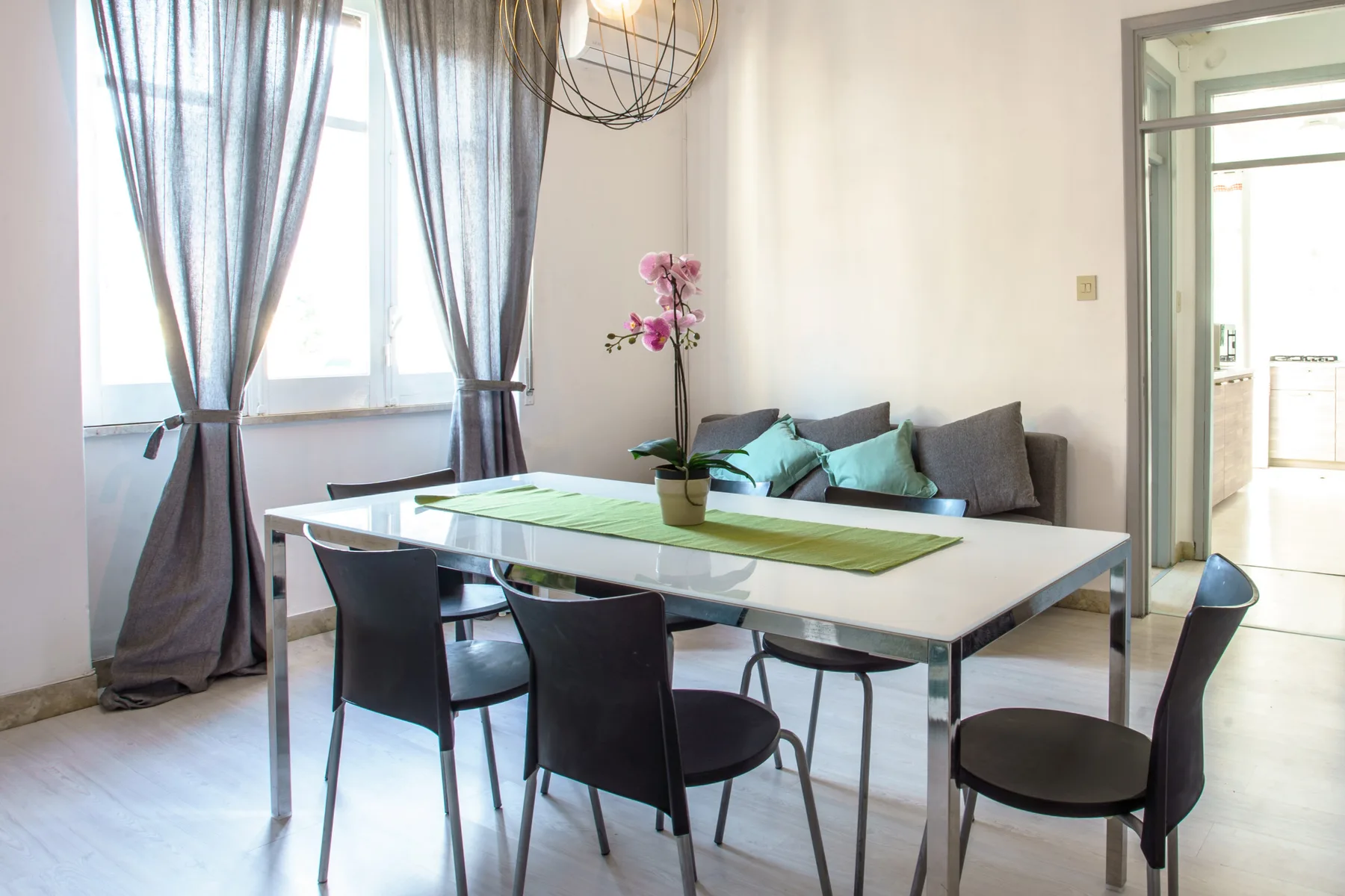 A bright dining area with a table, chairs, and a seating nook by the window.