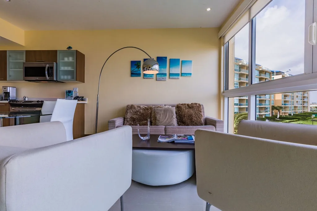 Relax in your bright living space with ocean-inspired décor and floor-to-ceiling windows overlooking the resort grounds, perfect for unwinding after a day of adventure.