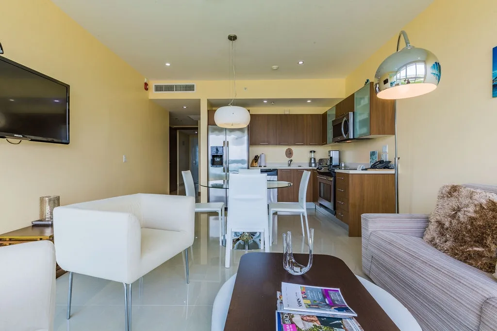Modern open-concept living with a fully-equipped kitchen, stylish dining area, and cozy seating—your perfect home base for vacation comfort and convenience.