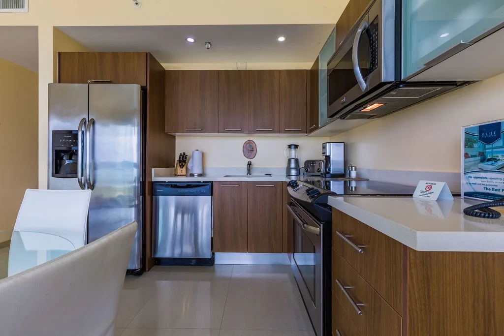 Your well-equipped kitchen features sleek stainless appliances, warm wood cabinetry, and ample counter space—perfect for preparing meals or enjoying morning coffee in style.