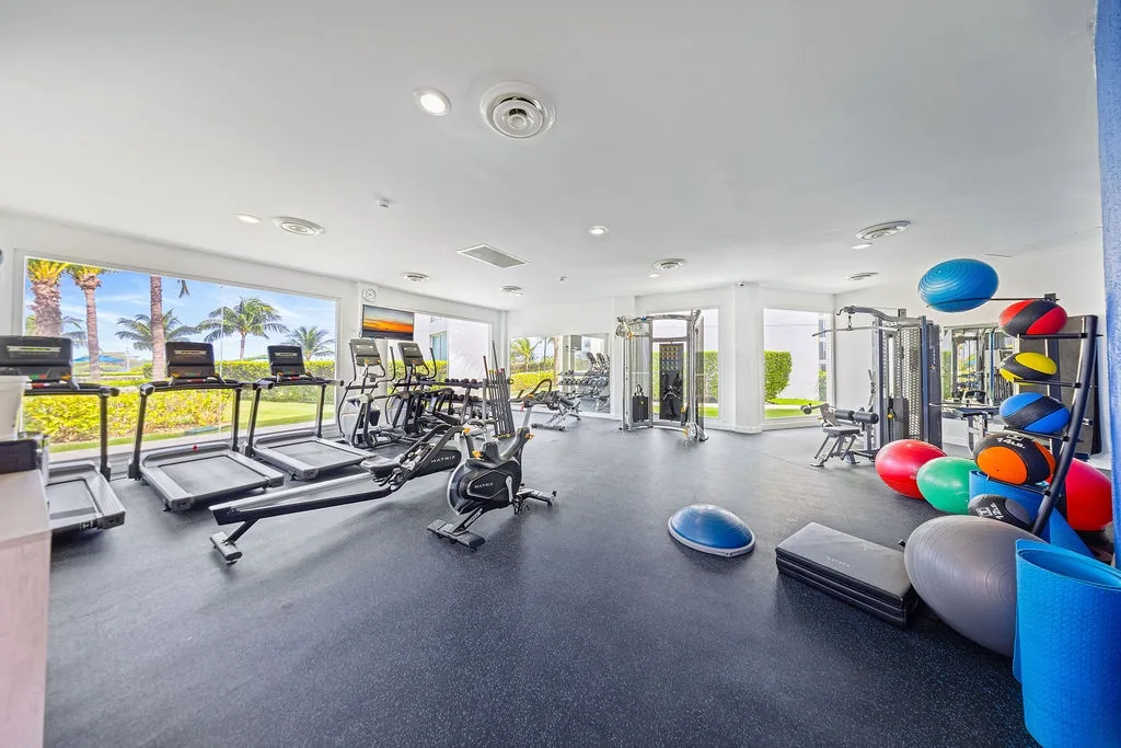 Stay energized in your fully-equipped fitness center with cardio machines, weights, and colorful exercise balls—all while enjoying tropical garden views through floor-to-ceiling windows.
