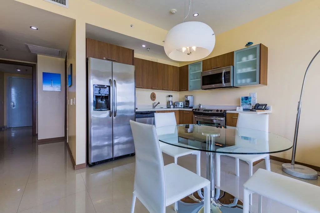 Settle into your fully equipped kitchen with stainless steel appliances and enjoy morning coffee at the sleek glass dining table—your home base for memorable meals together.
