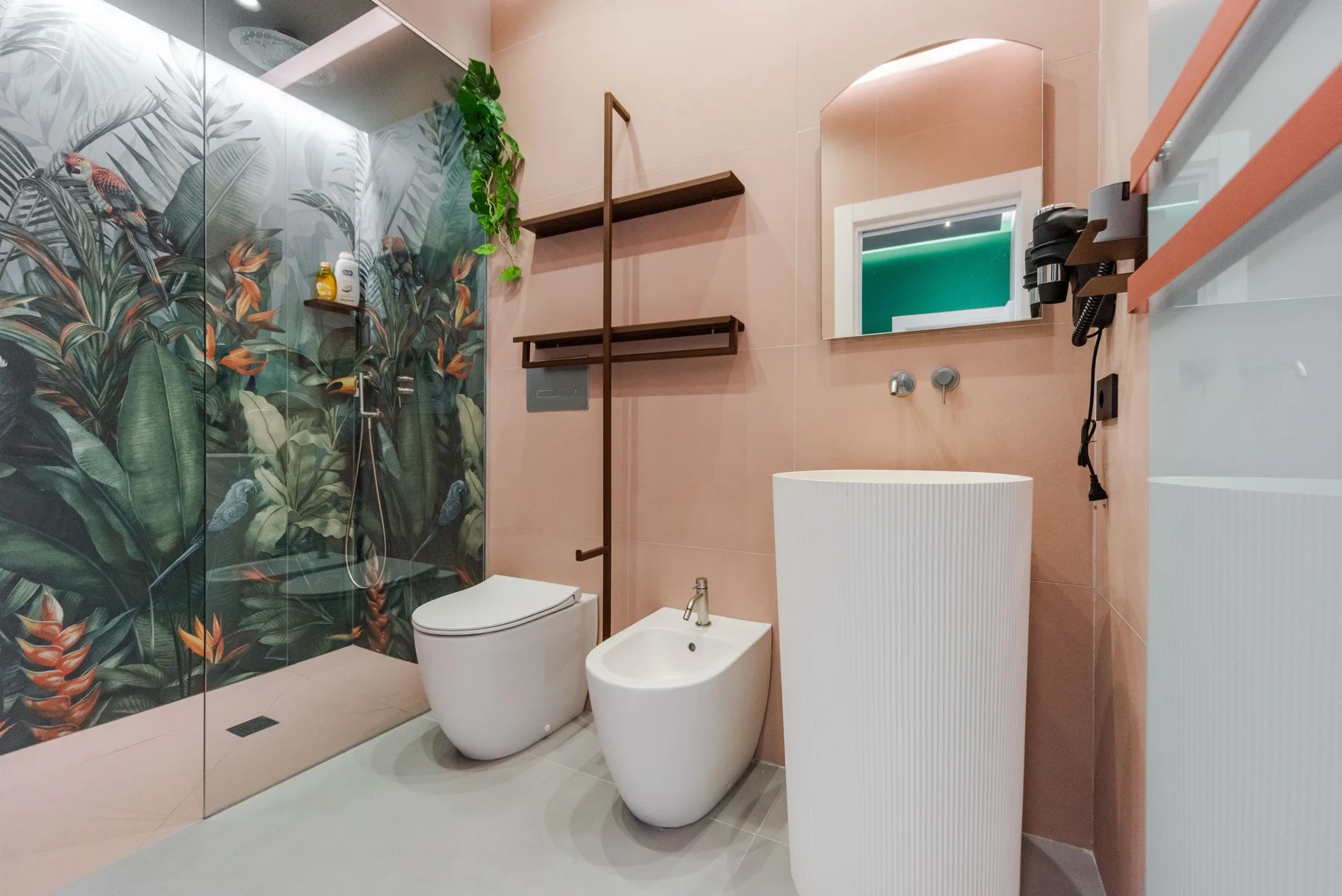 A bathroom with a glass shower and a white basin.