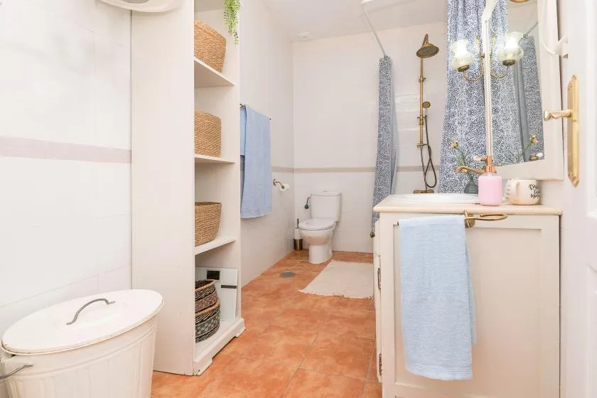 A bathroom with a sink, toilet, and shower.