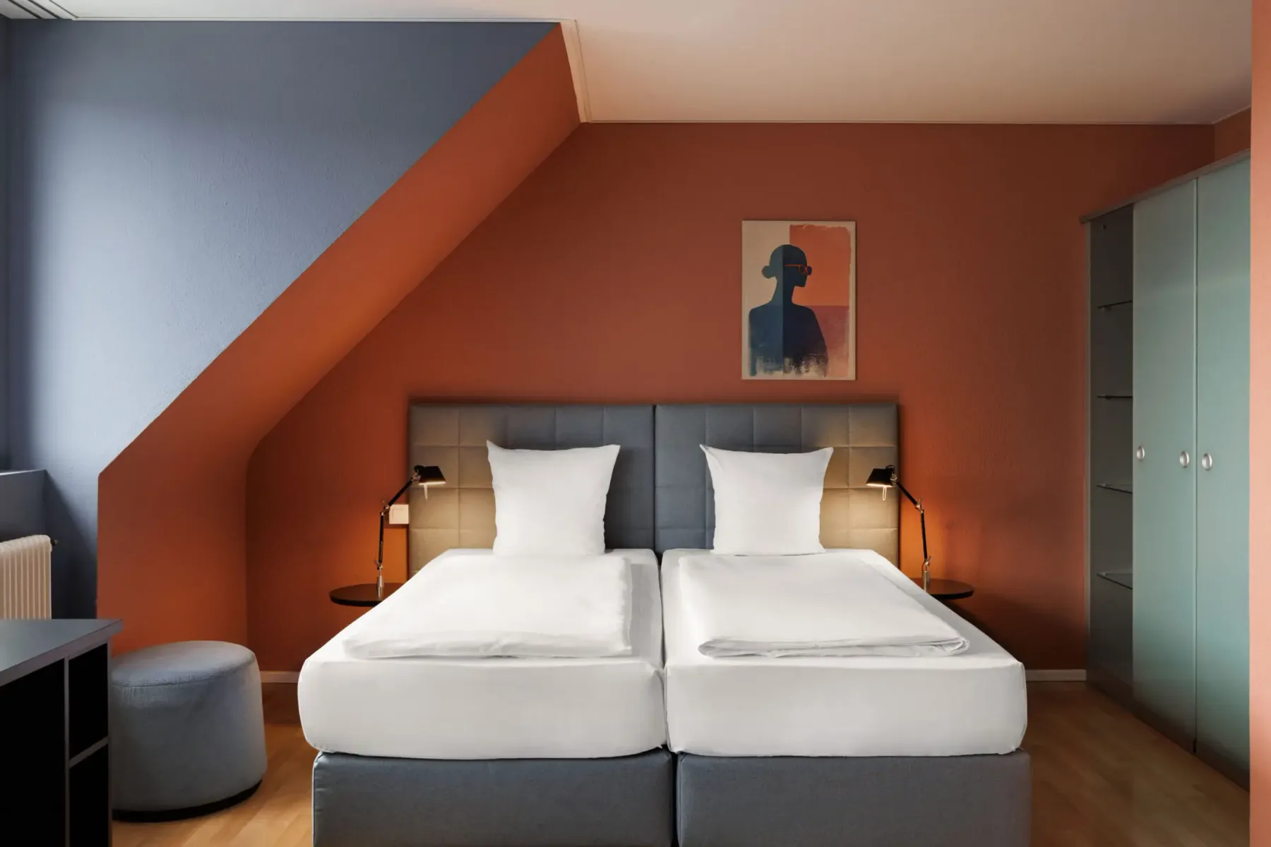 Two separate beds in a comfort room.