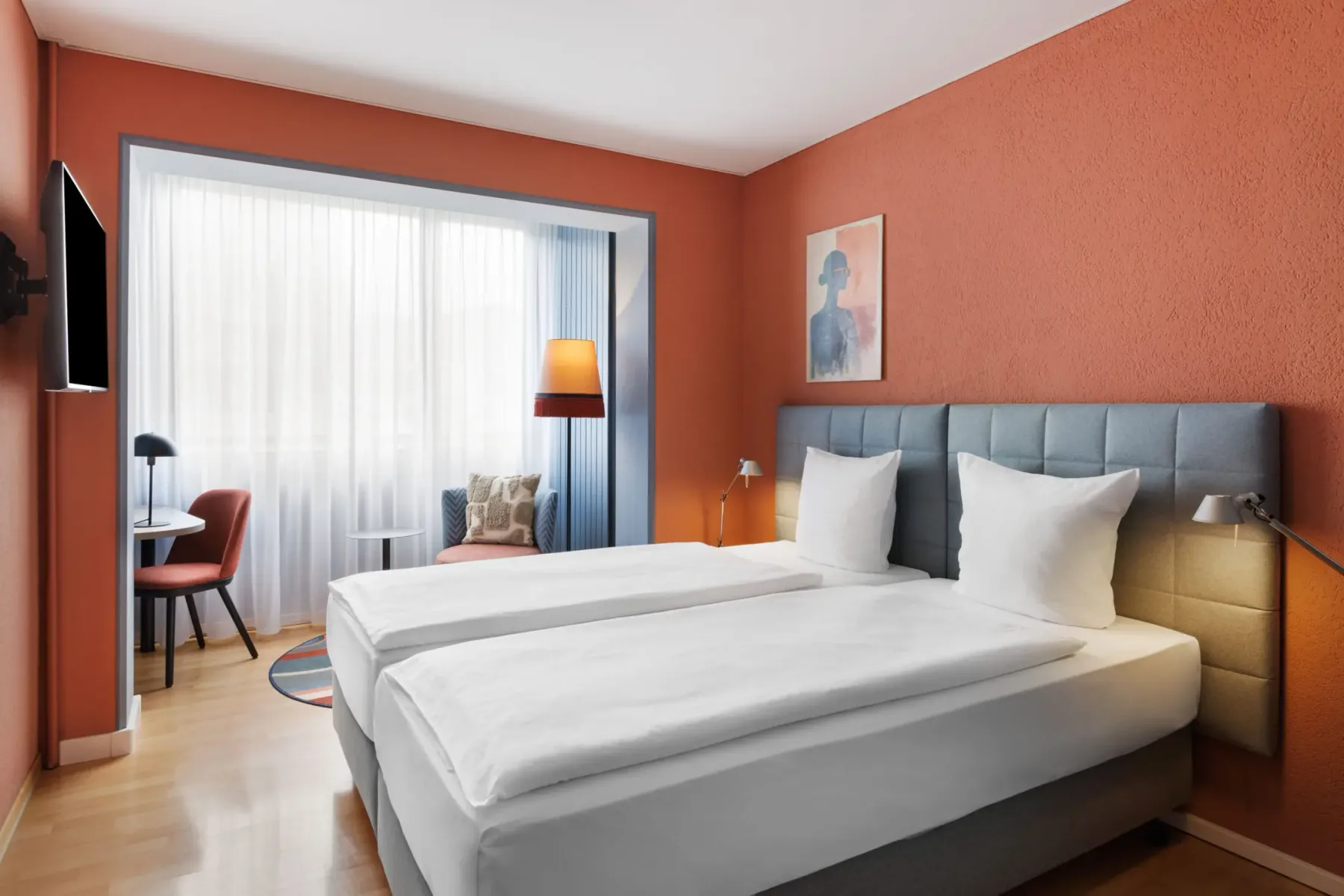 Comfort room with two separate beds and a seating area.