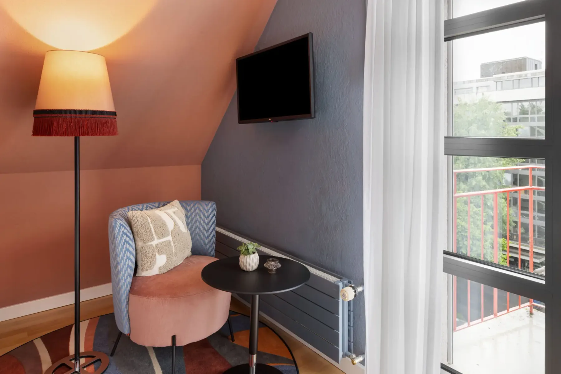 Window-side seating area in a single room.